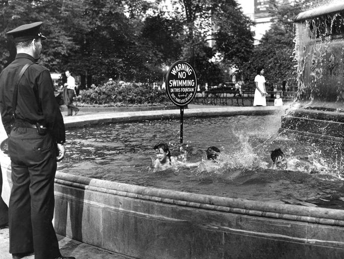 A friendly policeman allows children to swim in the
