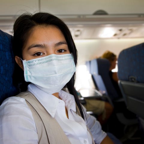 An airline passenger with a mask on.