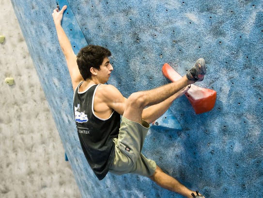 Climber Zach Levy competes in a bouldering competition