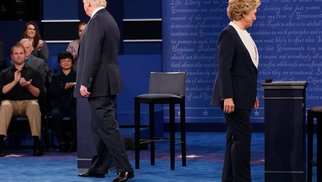 In this Oct. 9, 2016, file photo, Republican presidential candidate Donald Trump, left, and Democratic presidential candidate Hillary Clinton walk to their chairs as they arrive for the second presidential debate at Washington University in St. Louis.