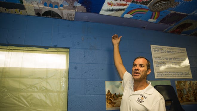 La Academia Dolores Huerta Principal Octavio Casillas explains how water damage has discolored the celling of a classroom, September 23, 2016, and in effort to make the classroom presentable again students painted over the stains.