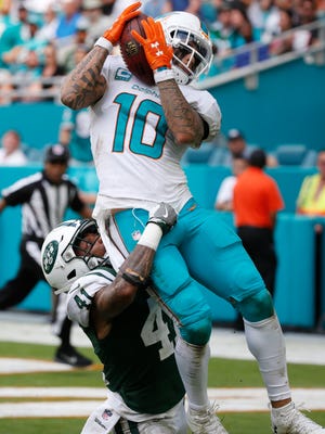 Miami Dolphins wide receiver Kenny Stills (10) catches a touchdown pass over New York Jets cornerback Buster Skrine (41), during the second half of an NFL football game, Sunday, Oct. 22, 2017, in Miami Gardens, Fla. (AP Photo/Wilfredo Lee)