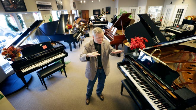 In this Dec. 3, 2014, photo, Jim Foster talks about his career at his Foster Family Music Center piano store, in Bettendorf, Iowa.