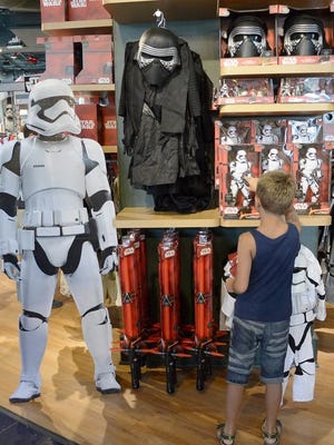 A boy looks at Star Wars toys and other memorabilia in 2015 at a Disney Store in Santa Monica, Calif.