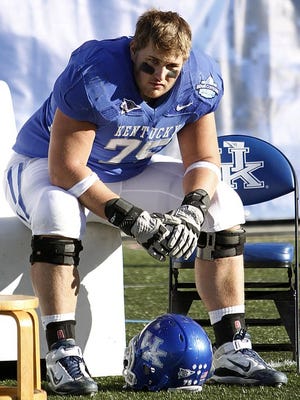 Kentucky's Brad Durham rests on the bench during the Cats' loss to Pittsburgh in the 2011 BBVA Compass Bowl in Birmingham, Ala.