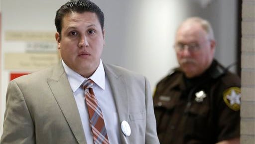 David Barajas leaves the courtroom during a break in his murder trial today in Angleton, Texas. Barajas is accused of fatally shooting Jose Banda in December 2012 minutes after Banda plowed into a vehicle that Barajas and his two sons had been pushing on a rural road.  Both of his sons were killed.