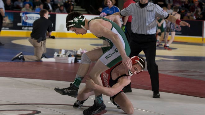 East Brunswick's Mark Schleifer tries to avoid a takedown by Kingsway's Trace Kinner in a 113-pound bout in the NJSIAA Wrestling Championships Friday night.