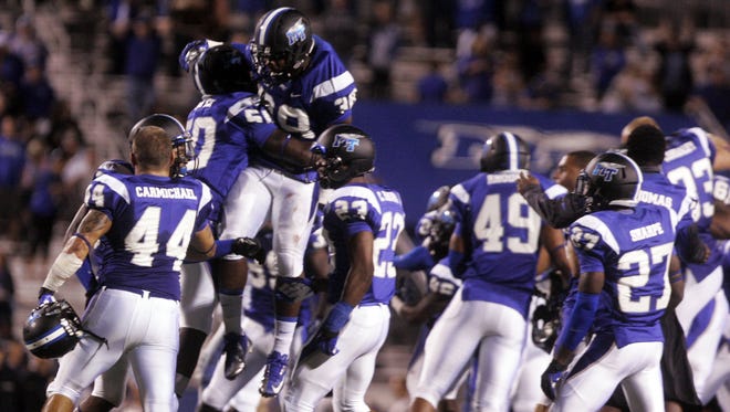 MTSU players celebrate their 17-15 win over Memphis in 2013 at Floyd Stadium.