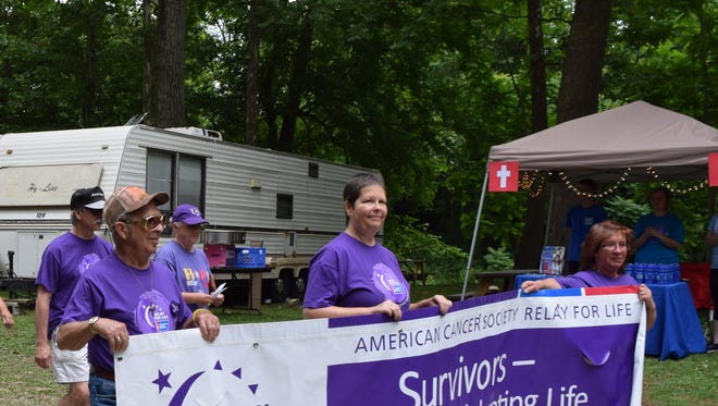 Cancer survivors and caregivers step off on the first lap of this year's Relay for Life of Licking County event Saturday.