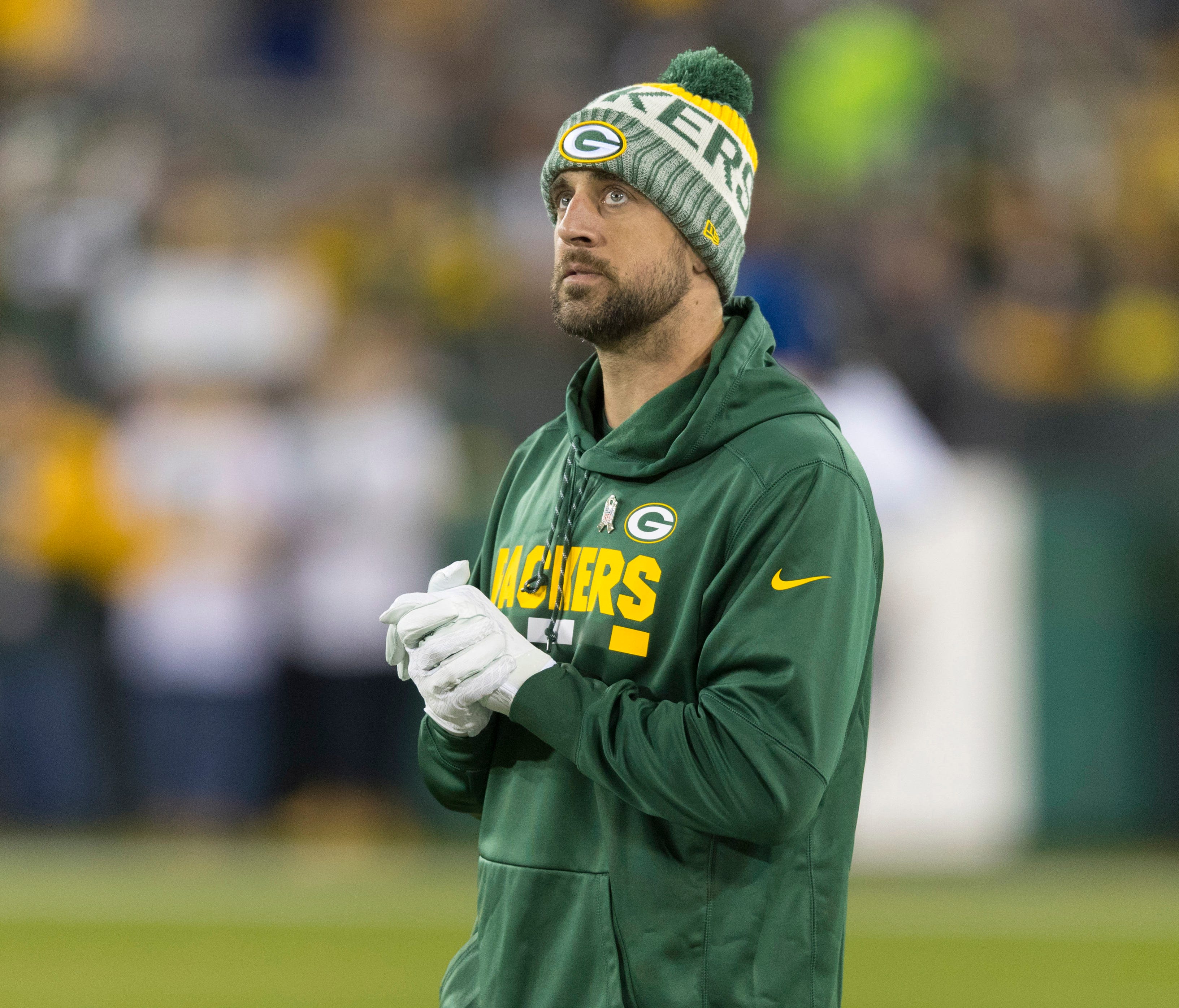 Green Bay Packers quarterback Aaron Rodgers walks on the field prior to the game against the Detroit Lions at Lambeau Field.