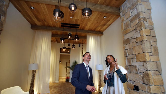 Lisa Sangster with Julia B. Fee Sotheby's International Realty shows Mayor Noam Bramson features in the lobby of the Lombardi apartment building.