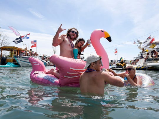 Revelers congregate around Gull Island, Mich., during the annual Jobbie Nooner in Lake St. Clair on Friday.