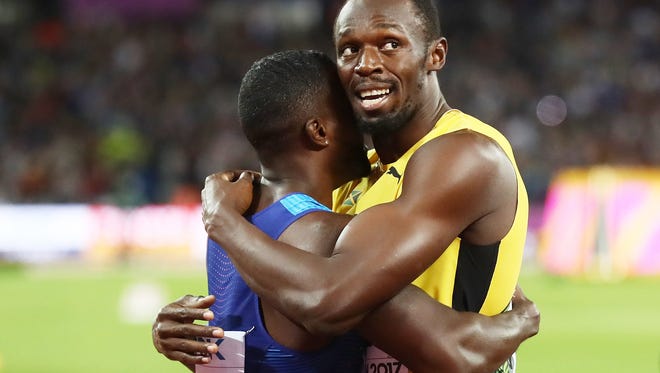 Usain Bolt, of Jamaica, hugs Justin Gatlin after Gatlin's win in the men's 100-meter final during the 16th IAAF World Athletics Championships London on Aug. 5, 2017.