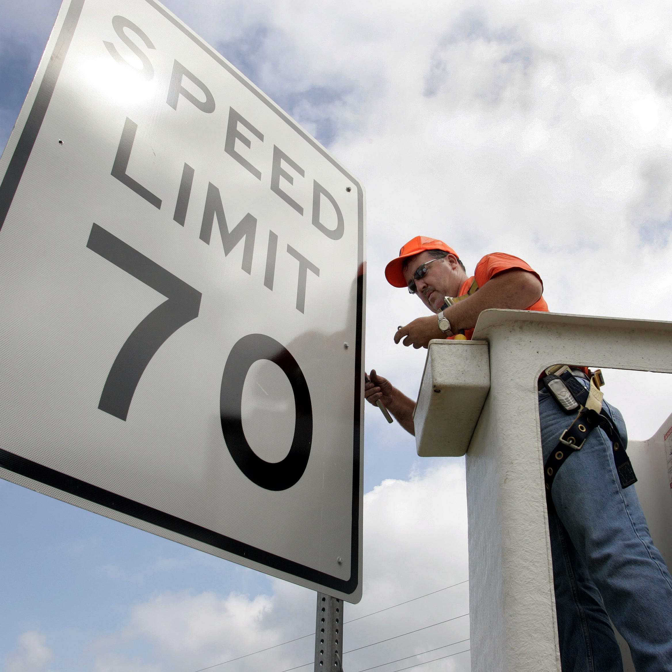 Indiana Department of Transportation worker Jim Hargus installs one the the new 70 mph speed limit signs along Interstate 65 in Lebanon, Ind., Tuesday, July 5, 2005. The legislature increased the speed limit on highways from 65 mph to 70 mph. (AP Photo/Michael Conroy)