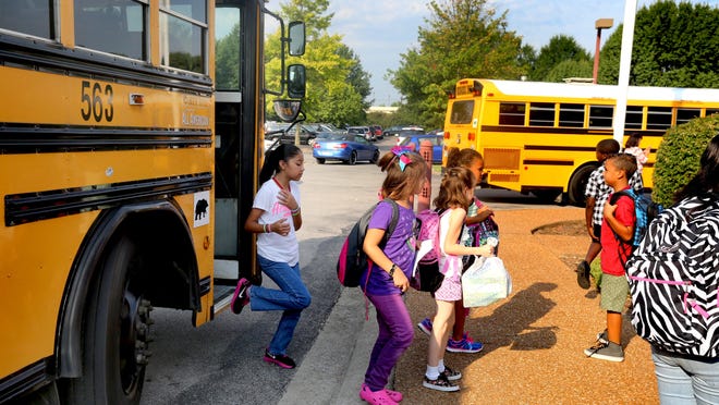 Black Fox Elementary School students get off the bus around 8:20 a.m. to start their first day of school.