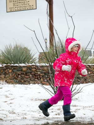 Breanna Marsteen, 8, plays in the snow in Wickenburg Wednesday, Dec. 31, 2014.