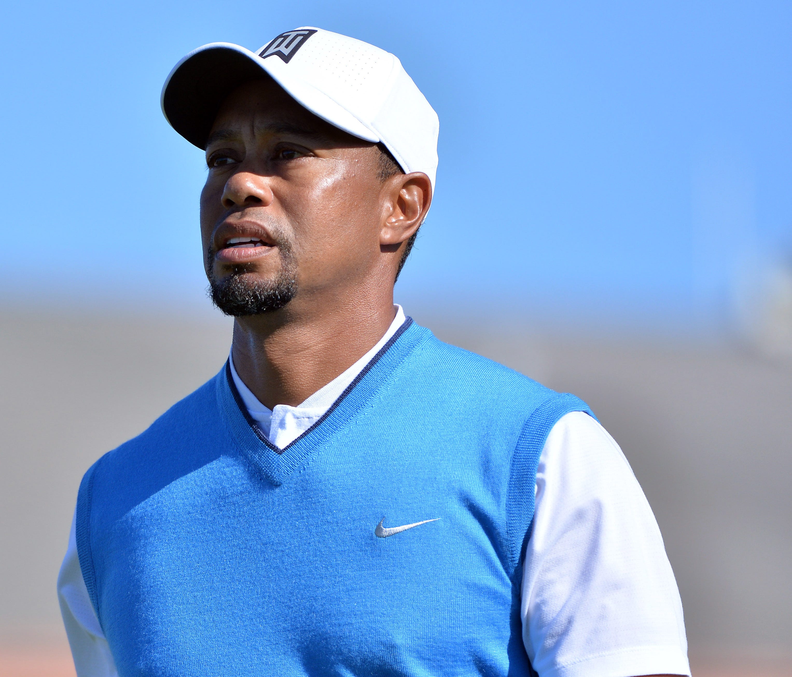 Tiger Woods looks on after teeing off on the 1st hole during the first round of the Farmers Insurance Open golf tournament at Torrey Pines Municipal Golf Course.