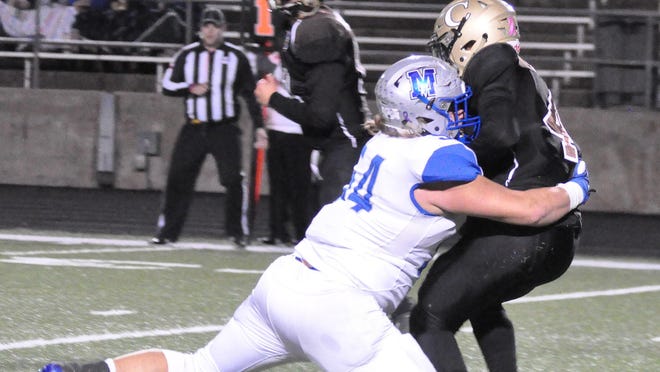 McCallum's Connor Boggs drops Crockett's Josh Early for a 6-yard loss in a district game last season. Boggs is part of a deep and talented defensive line for the Knights.