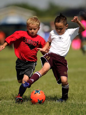 Bandits player Charlie Longhofer (left) tries to steal the ball away from a Legacy player during the 3v3 Live soccer tournament June 17 at the Lee Athletic Complex.