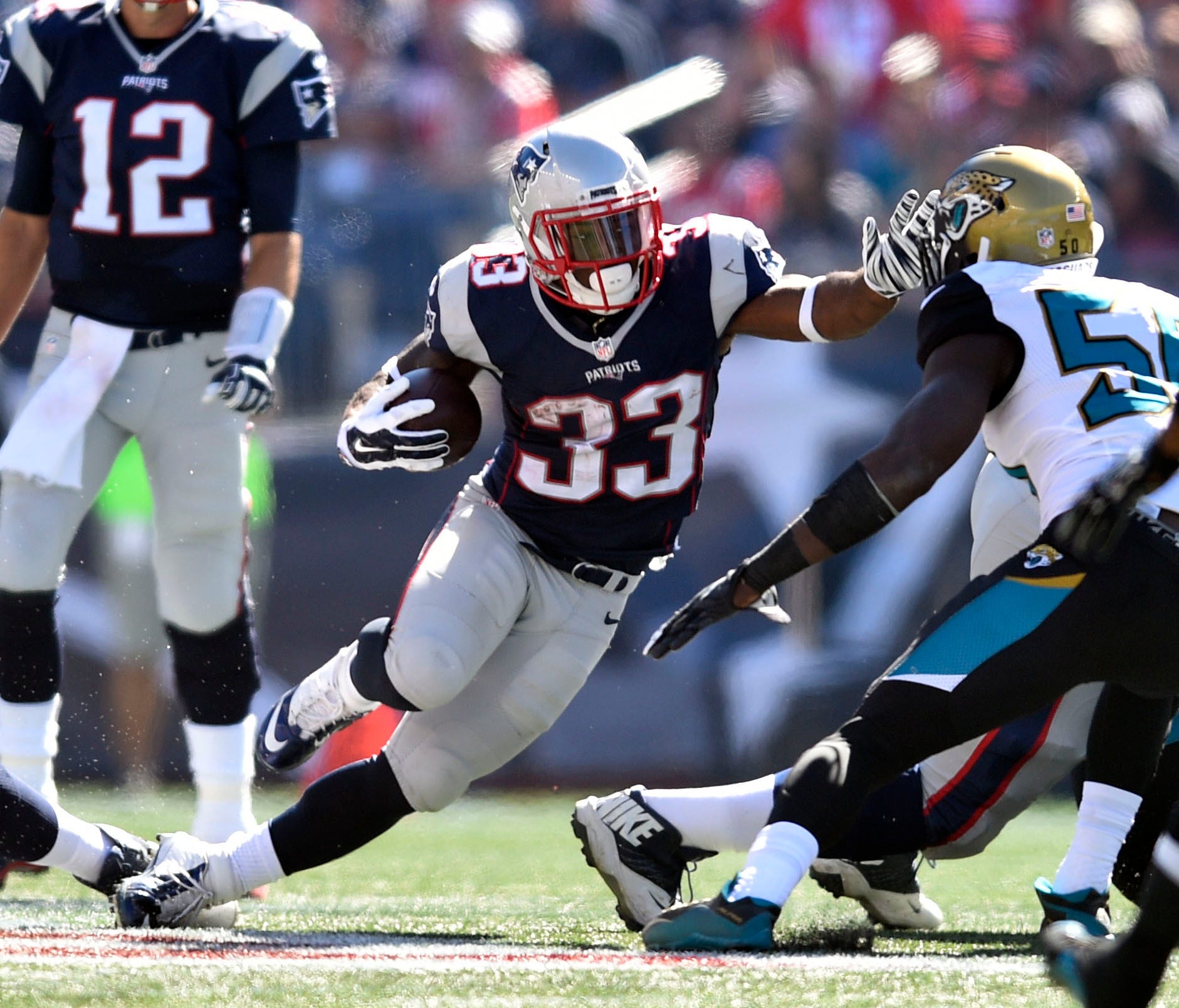 New England Patriots running back Dion Lewis (33) carries the ball in the first quarter against the Jacksonville Jaguars at Gillette Stadium.