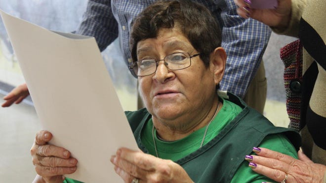 Bethlehem Center volunteer Rita Perez reads the certificate of recognition for her service presented to her by Assemblyman Devon Mathis, Friday.