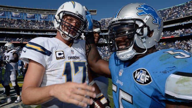 Linebacker Stephen Tulloch, right, of the Detroit Lions congratdulates quarterback Philip Rivers of the San Diego Chargers after a game Sept. 13, 2015, in San Diego.