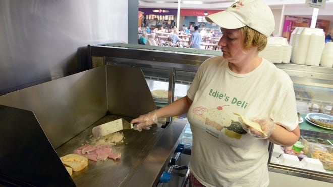 Melissa Pettit prepares a Reuben sandwich at Edie's Deli, located in the Colony Square Mall food court on Maple Avenue in Zanesville.