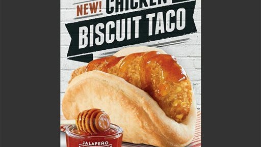 This image provided by Taco Bell shows an ad shows the restaurant chain's new chicken "biscuit taco". Taco Bell's new ad campaign promoting its the new offering aims to paint McDonald's Egg McMuffins as boring, routine food for the brainwashed. (AP Photo/Taco Bell)