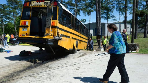 More than 20 Charlton-Pollard Elementary students and one adult were hospitalized when a Beaumont school district bus was involved in a traffic accident on U.S. 69 in Lumberton, Texas, Wednesday, April 5, 2017. The bus was taking several dozen Charlton-Pollard Elementary School students and several adults back to school from a Big Thicket field trip. Officials had no information on how the accident happened, but photos showed the bus veered off the road, through a roadside ditch and into a rock. (Guiseppe Barranco/The Beaumont Enterprise via AP)