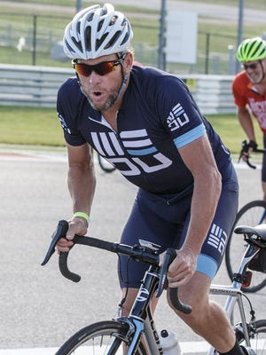 Lance Armstrong participates in bike night at Circuit of the Americas where cyclists ride the Formula One track in Austin, Texas.