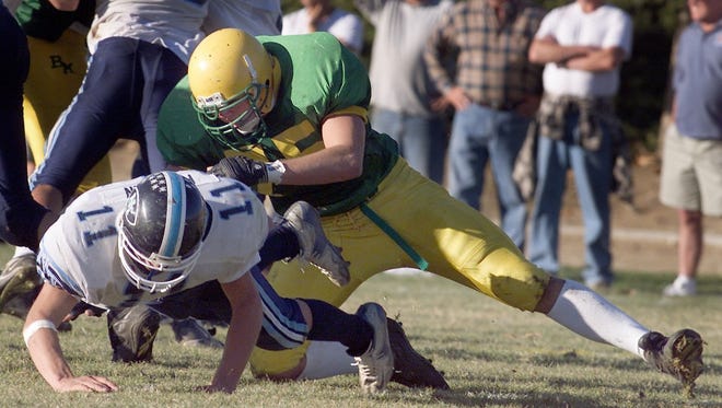 Michael Yenick brings down North Tahoe quarterback Billy Freeman during a game in 1999. Yenick was a star at Manogue who went on to play for the Wolf Pack.