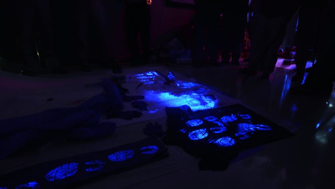 Items are sprayed with Bluestar, a chemiluminescence, to find blood stains that may not be seen by the naked eye. Law enforcement officials  took part in a crime scene management school sponsored by the National Forensics Academy, Wednesday afternoon.