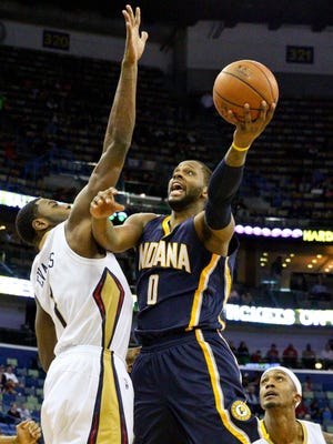Feb 11, 2015; New Orleans, LA, USA; Indiana Pacers guard C.J. Miles (0) shoots over New Orleans Pelicans guard Tyreke Evans (1) during the first quarter of a game at the Smoothie King Center. Mandatory Credit: Derick E. Hingle-USA TODAY Sports