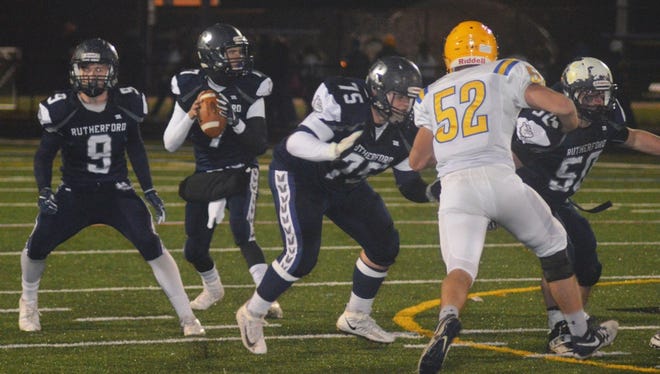 Rutherford quarterback Kyle Russell being protected by a phalanx of blockers against Lyndhurst.