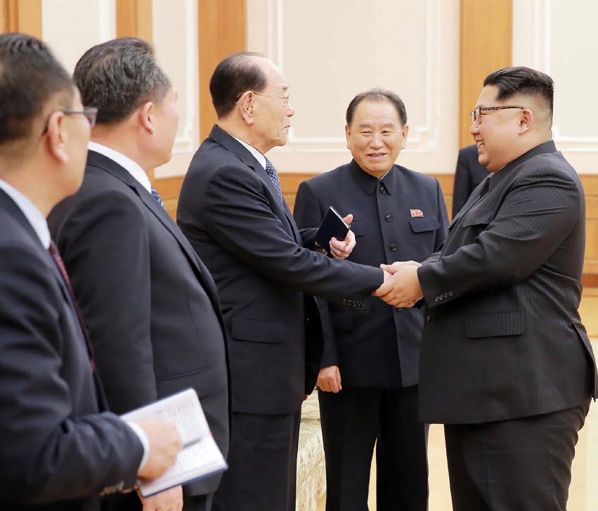 North Korean leader Kim Jong Un (R) greets members of the high-level delegation that visited South Korea to attend the opening ceremony of the Winter Olympics. The South Korean government on Wednesday announced they would foot the $2.6 million tab fo