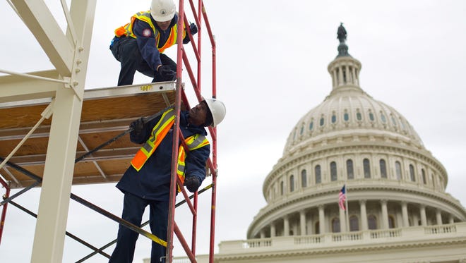 Construction continued for the inauguration and swearing-in ceremonies for President-elect Donald Trump on the Capitol steps in Washington.