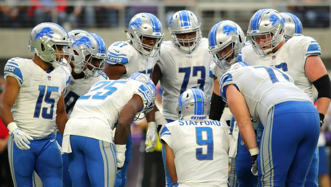 The Detroit Lions huddle around Matthew Stafford in the second half of their 14-7 win over the Minnesota Vikings on Oct. 1, 2017 at U.S. Bank Stadium in Minneapolis.