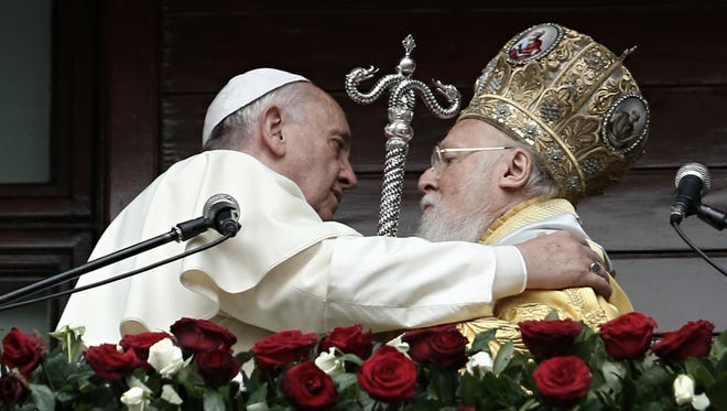 Pope Francis, left, and Ecumenical Patriarch Bartholomew I of Constantinople speak to the faithful on Sunday in Istanbul.