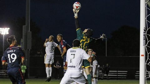 Rhinos goalkeeper John McCarthy (77) tips a shot over the goal during the second half against the New England Revolution at Stevenson Field. The Revs won 2-1.