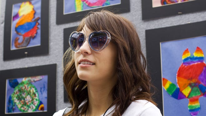 Jessica White looks over children's artwork at the annual St. George Art Festival in this file photo.