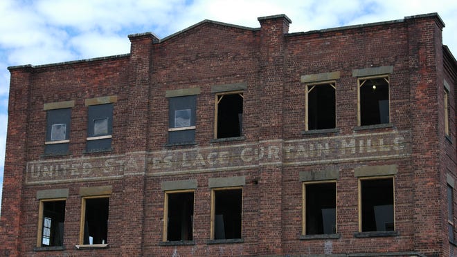 
The front facade of the mills complex still displays the company name, United States Lace Curtain Mills.
