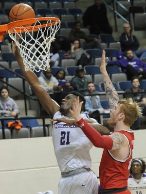 ACU's Jalone Friday, left, drives to the basket against a Lamar defender. ACU won the game 67-64 on Saturday, Jan. 14, 2017 at Moody Coliseum.