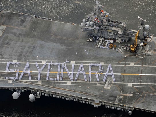 Crew members aboard the USS Kitty Hawk formed the word "sayonara," when the U.S. aircraft carrier departed a port near Tokyo for the final time in 2008.