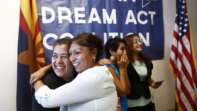 Yadira Garcia hugs Macruz Ramirez (right) following an Arizona Dreamers press conference on Monday, July 7, 2014 in Phoenix after an appeals court blocked Arizona Gov. Jan Brewer's policy of denying driver's licenses to young immigrants who have gotten work permits and avoided deportation under an Obama administration policy.