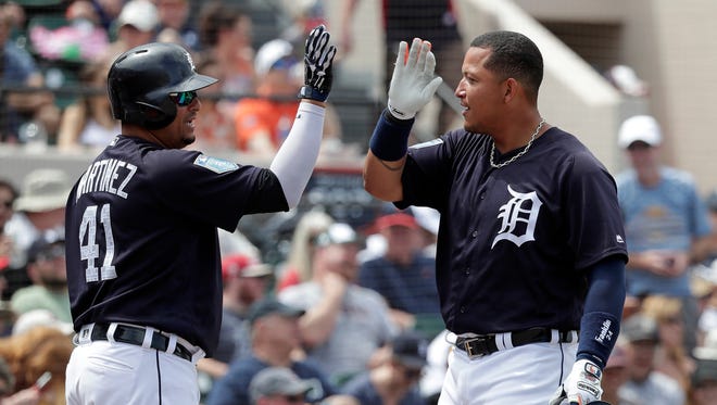 Tigers first baseman Miguel Cabrera gets a high five from teammate Victor Martinez after hitting a home run in the fourth inning of the Tigers' 10-3 exhibition win over the Braves on Sunday, March 25, 2018, in Lakeland, Fla.