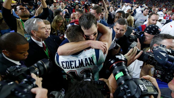 Tom Brady hugs wide receiver Julian Edelman after defeating the Seattle Seahawks in Super Bowl XLIX at University of Phoenix Stadium. Photo: Mark J. Rebilas-USA TODAY Sports