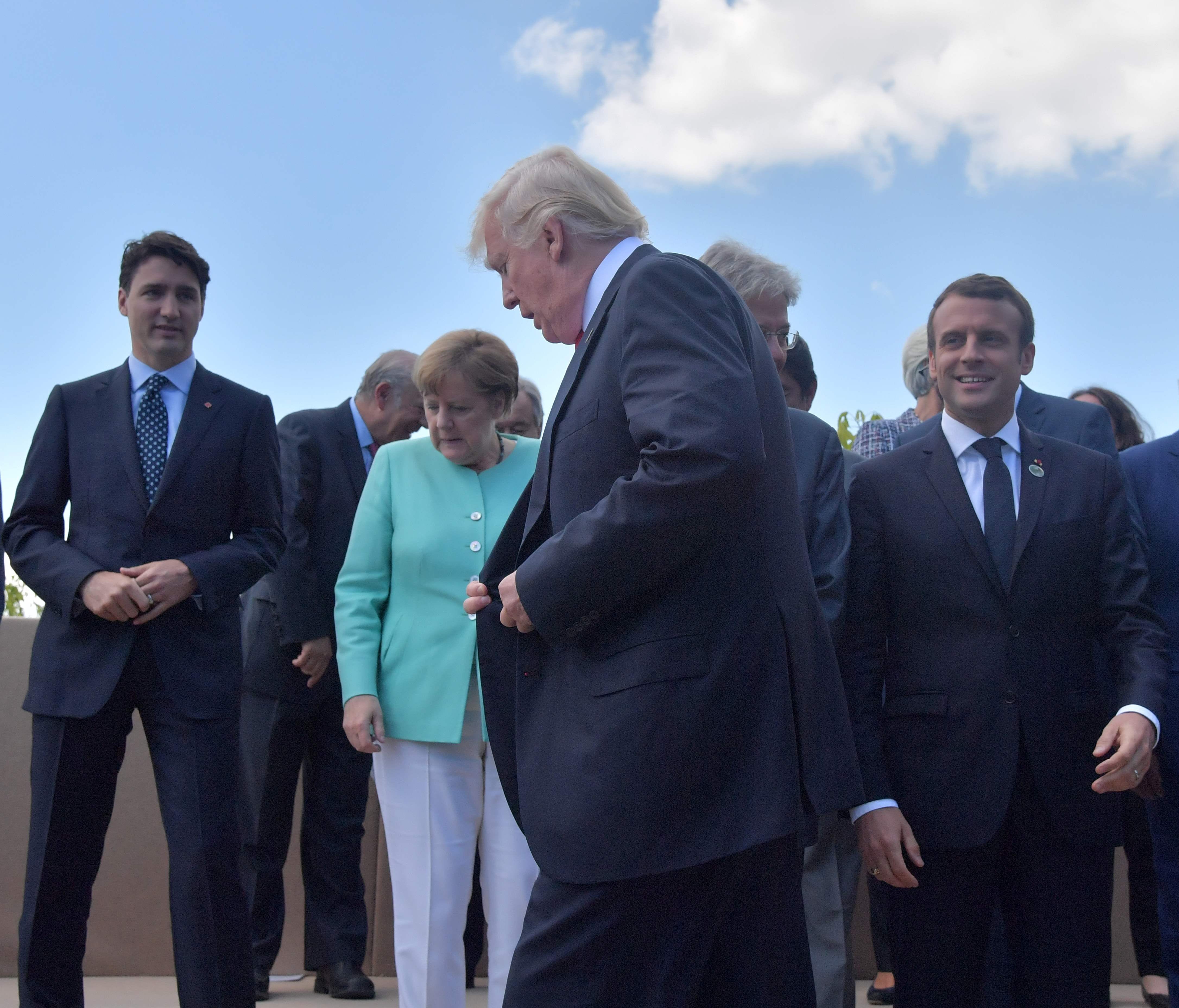 President Trump walks past Canadian Prime Minister Justin Trudeau, German Chancellor Angela Merkel, French President Emmanuel Macron and Niger's President Mahamadou Issoufou at a 