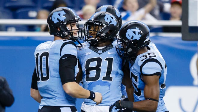 Dec 26, 2014; Detroit, MI, USA; North Carolina Tar Heels wide receiver Kendrick Singleton (81) receives congratulations from quarterback Mitch Trubisky (10) and wide receiver Damien Washington (35) after scoring a touchdown in the fourth quarter against the Rutgers Scarlet Knights in the 2014 Quick Lane Bowl at Ford Field. Rutgers won 40-21. Mandatory Credit: Rick Osentoski-USA TODAY Sports