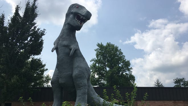 A T. rex sculpture at Sutton Elementary School awaits relocation.
