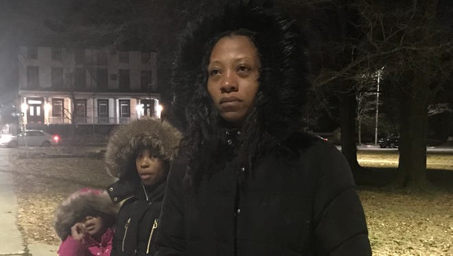 Stacey Watson lost her cousin Noel McClinton in Saturday's fatal shooting. She attended Monday's rally with her two young daughters.